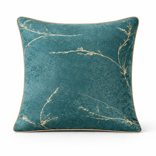Teal pillow with gold leaf pattern on a white background